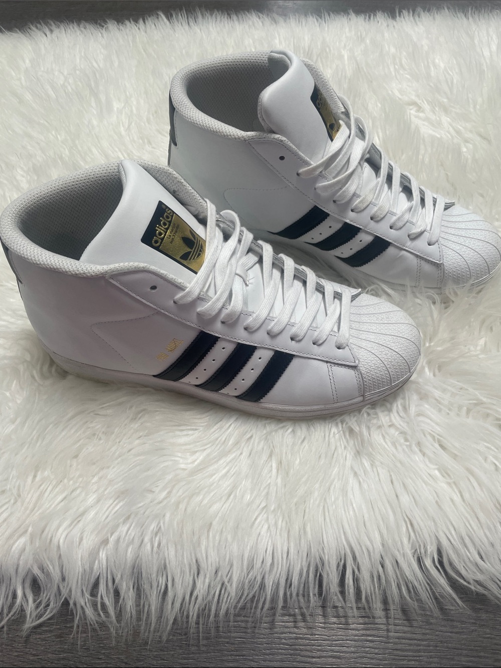 Adidas Pro Model sneakers in white with black stripes with gold accents